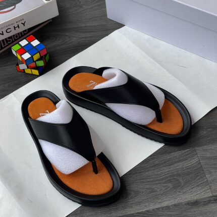 Add a pop of bold color to your summer wardrobe with these Fashion Thong Sandals. Designed for the woman who refuses to choose between style and support, these sandals feature a sleek black strap design paired with a high-visibility orange footbed that stands out from the crowd.