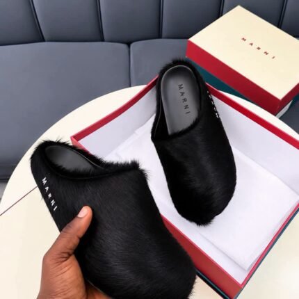 These Marni Fussbett Sabot slippers feature a beige long hair calfskin upper with a relaxed slip on mule design and a branded leather insole The distinctive texture and neutral color create a refined look for casual styling